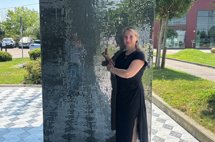 Angela Herrmann in front of a mosaic wall from SICIS